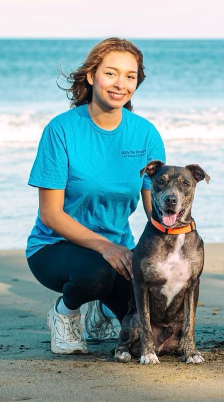 Michelle Sanchez with a dog on the beach