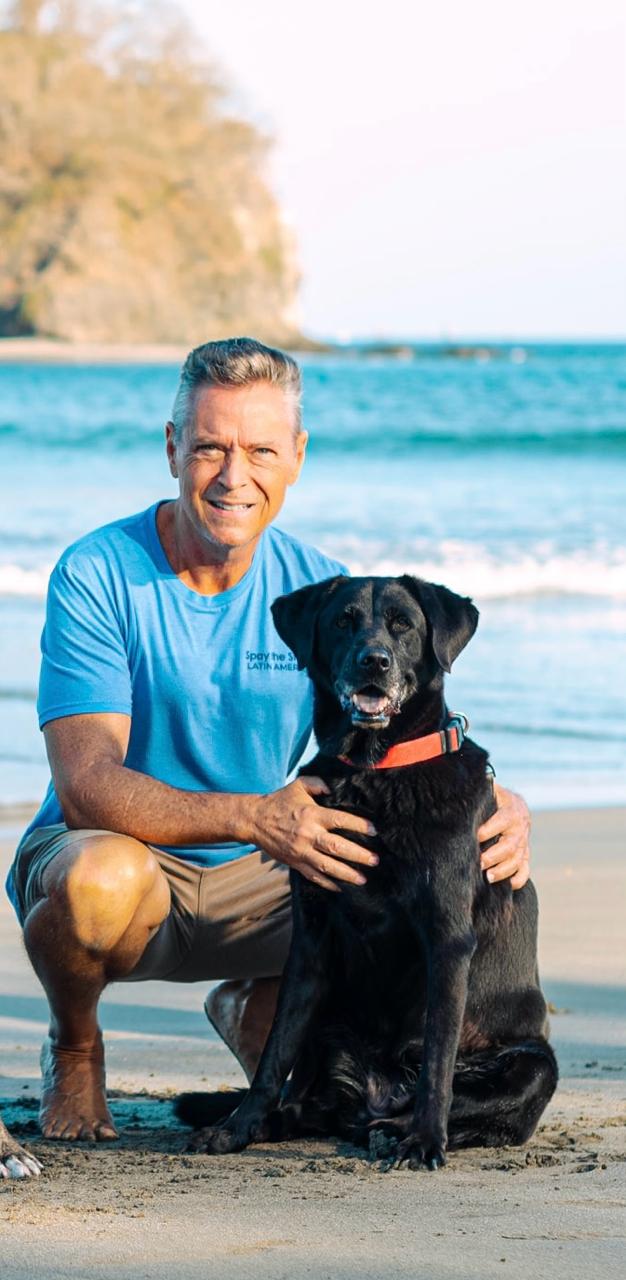 Mike Stooksbury with a dog on the beach